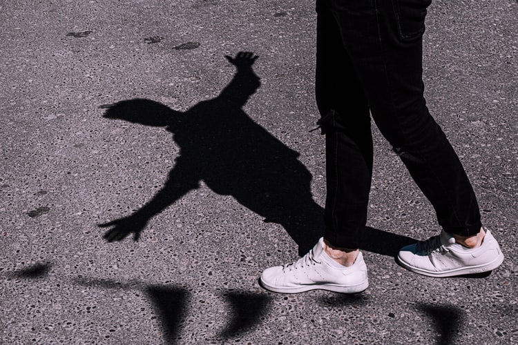 person and shadow balancing on line